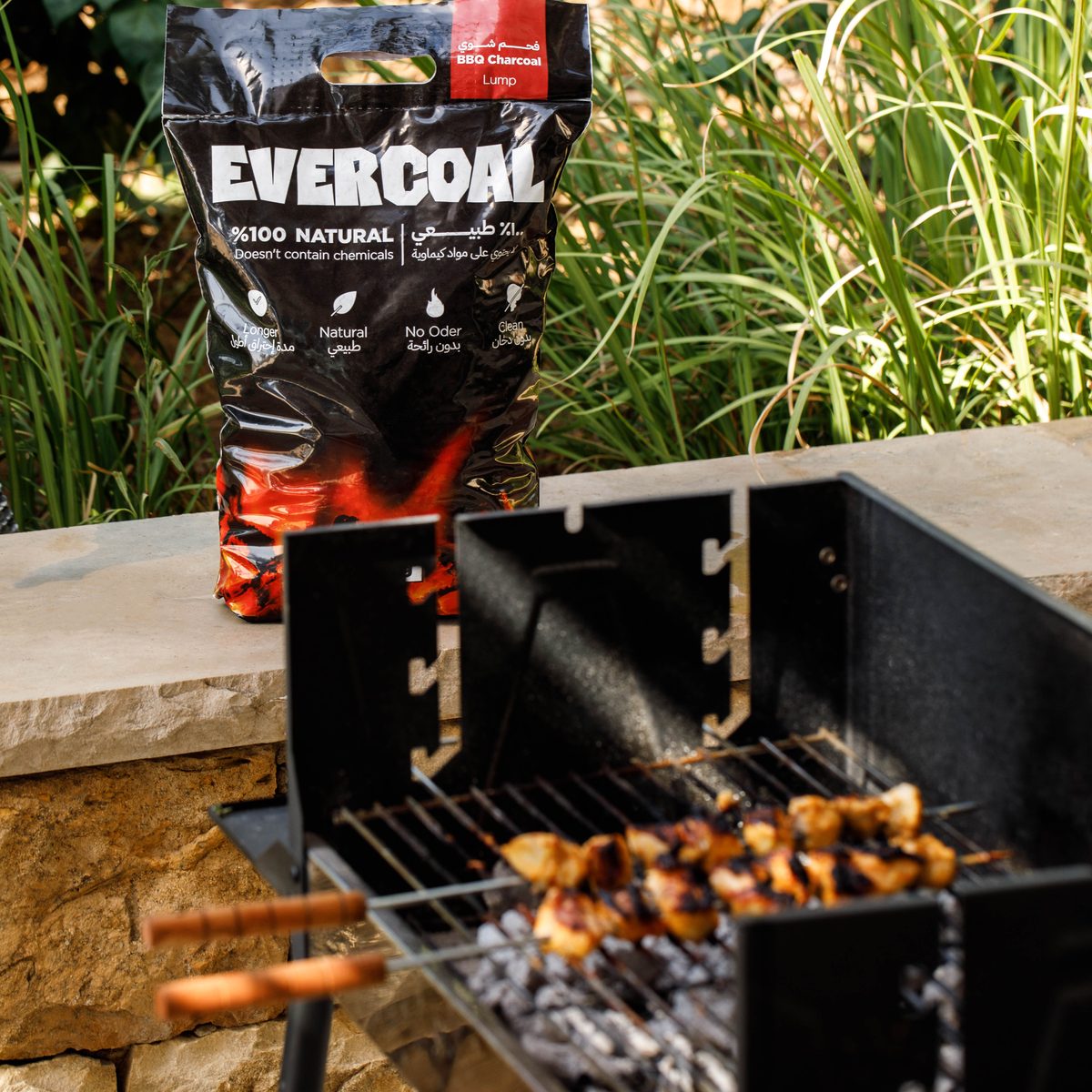 Evercoal charcoal beside a lit garden barbecue